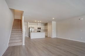 Charlotte townhouse for rent - an empty living room with a staircase in the background