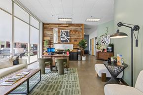Petaluma apartment for rent - A modern office space with a wooden accent wall and a variety of seating options.