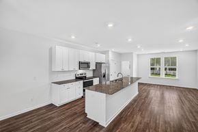 North Charleston apartment for rent - A modern kitchen with white cabinets and a central island.