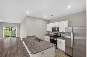 Myrtle Beach triplex for rent - A kitchen with a granite countertop and stainless steel appliances.