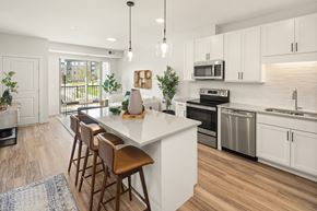 Coon Rapids apartment for rent - A modern kitchen with white cabinets and a central island.