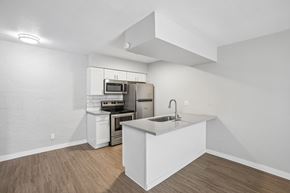 Tempe apartment for rent - A kitchen with white cabinets and a white island.