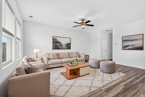 Summerville townhouse for rent - A living room with a white couch, a coffee table, and a ceiling fan.