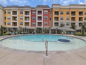 Las Vegas apartment for rent - A large swimming pool in front of a multi-story apartment building.