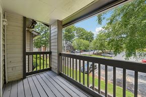 Lawrenceville townhouse for rent - A balcony with a view of a street and trees.
