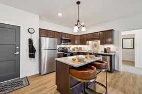 Blaine apartment for rent - A modern kitchen with a wooden table and chairs.