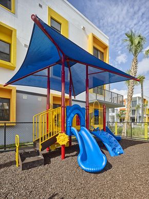 Pompano Beach apartment for rent - Outdoor playground at Gateway Luxury Apartments in Pompano Beach, featuring safe, modern play structures for children in a landscaped setting.