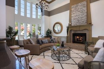 Elegant clubroom with kitchen, fireplace, & tv