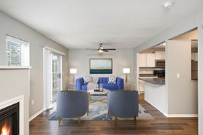 Burnsville townhouse for rent - A living room with a fireplace and two blue chairs.