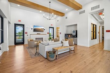 Universal City apartment for rent - A living room with a white couch and a wooden floor.