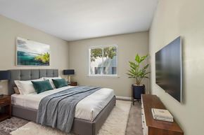 Charlotte apartment for rent - A bedroom with a bed, nightstand, and a painting on the wall.