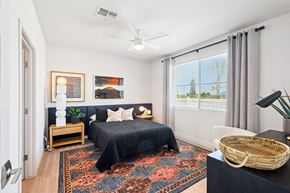 Phoenix apartment for rent - A bedroom with a large bed and a ceiling fan.