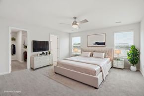 Fountain Inn townhouse for rent - A bedroom with a large bed, a television, and a plant.