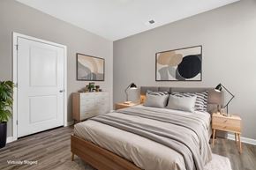 Myrtle Beach triplex for rent - A bedroom with a large bed and a white door.