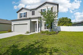 Ruskin apartment for rent - A house with a grey and white exterior and a large front yard.