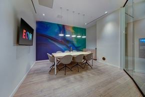 Fort Lauderdale apartment for rent - a conference room with a table and chairs and a large painting on the wall