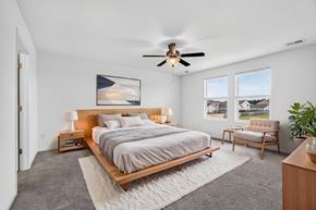 Summerville townhouse for rent - A bedroom with a large bed and a ceiling fan.