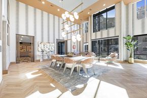 Las Vegas apartment for rent - A large, modern dining room with a long table and chairs.