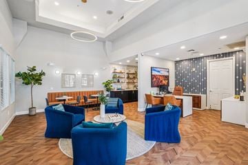 Phoenix apartment for rent - A living room with blue chairs and a white coffee table.