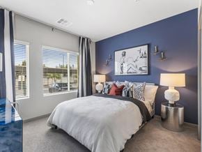 Las Vegas apartment for rent - A bedroom with a large bed and a picture on the wall.