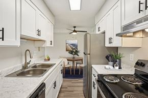 Denver apartment for rent - Modern kitchen at Trailgrove Apartments with white shaker cabinets and stainless-steel appliances