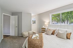 Geneva apartment for rent - Bright bedroom with plush bedding and natural light at Ashford at Geneva – pet-friendly apartments in Geneva, Illinois
