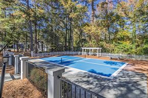 Macon apartment for rent - Element at 3900, Macon Apartments A blue pool surrounded by a fence and trees.