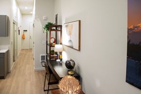 Bothell apartment for rent - a dining room with a table and chairs and a hallway with a door
