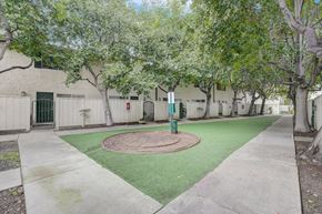 San Jose apartment for rent - One-Bedroom Apartments in San Jose, CA - Los Gatos Creek - Outdoor Courtyard With Turf Lawn, Mature Shade Trees, Concrete Pathways, and Apartment Building Entrances.