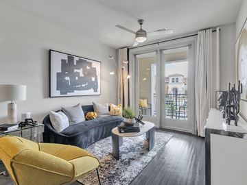 Las Vegas apartment for rent - A modern living room with a yellow chair and a grey sofa.