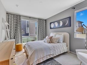 Henderson apartment for rent - A bedroom with a large bed and a window with curtains.