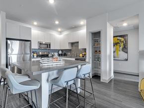 Las Vegas apartment for rent - A modern kitchen with a large island and bar stools.