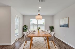 Ocean Springs apartment for rent - A dining room with a wooden table and chairs.