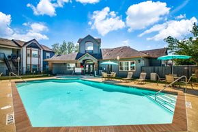 Beaumont apartment for rent - Pet-Friendly Apartments in Beaumont, TX – Breakwater Bay - swimming pool with umbrellas and beach chairs