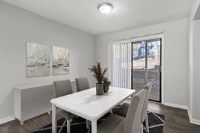 Macon apartment for rent - Element at 4411 Macon Apartments A dining room with a white table and chairs.