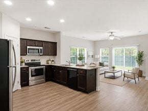 Richmond Hill townhouse for rent - A modern kitchen with dark brown cabinets and stainless steel appliances.