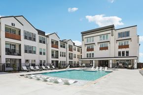 Celina apartment for rent - A large white building with a pool in front.