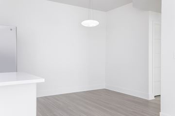 Las Vegas apartment for rent - A white room with a light hanging from the ceiling and a white counter.