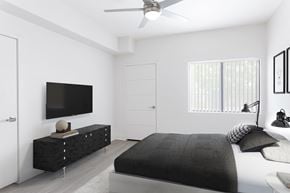 Las Vegas apartment for rent - a bedroom with a bed and a tv on the wall