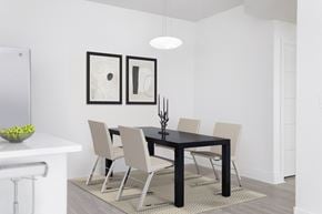 Las Vegas apartment for rent - a dining room with a black table and white chairs