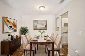 Tampa apartment for rent - A dining room with a wooden table and chairs.