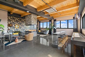 Rooftop indoor lounge with fireplace and shuffleboard