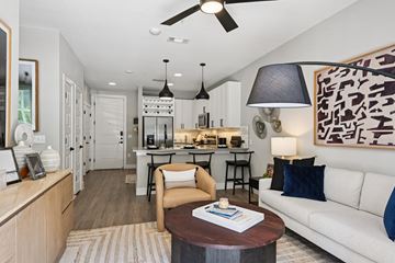 Dallas apartment for rent - A modern living room with a white sofa and a coffee table.