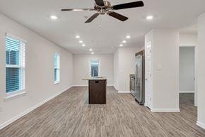 Ocean Springs apartment for rent - A spacious room with a ceiling fan and wooden flooring.
