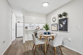 Jacksonville apartment for rent - A dining room with a table set for two and a kitchen in the background.