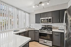Tempe apartment for rent - A modern kitchen with a white countertop and stainless steel appliances.