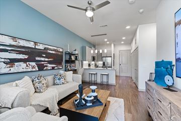 Mckinney apartment for rent - A living room with a white couch and a painting on the wall.