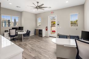 Phoenix apartment for rent - A spacious office with a white reception desk and a ceiling fan.