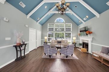 Montgomery apartment for rent - A living room with a checkered sofa and a fireplace.