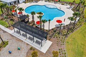 Summerville townhouse for rent - A pool with a black roof and red umbrellas.